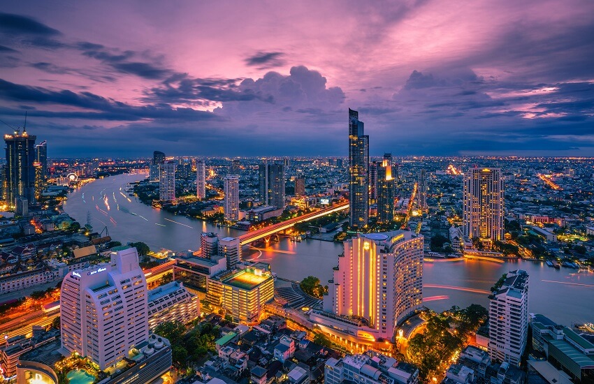 Bangkok skyline at dusk with Chao Phraya River and skyscrapers
