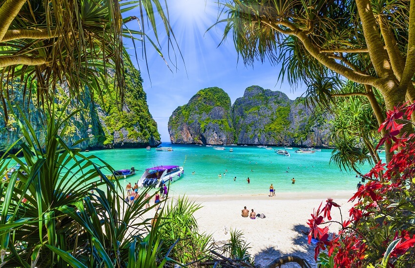 View of Maya Bay Thailand with limestone cliffs and boats